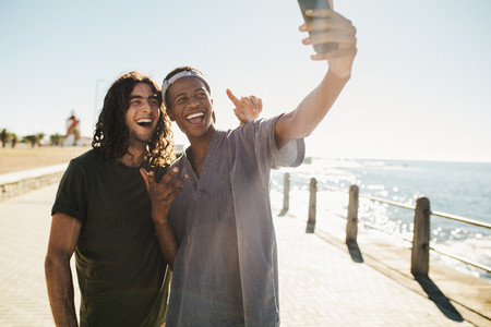 Friends make a selfie on the seaside hangout