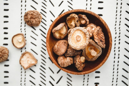 Chinese dried mushrooms Shiitake in a wooden bowl on a table  The concept of medicinal superfoods for health  Top view  flat lay