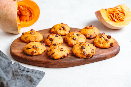 Pumpkin cookies with chocolate chips made from cake mix on a wooden tray