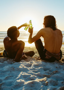 Friends partying in the beach with beers