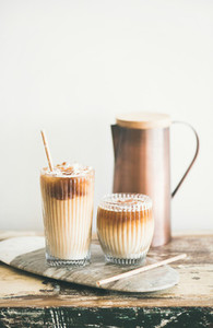 Iced coffee drink in tall glasses white wall at background