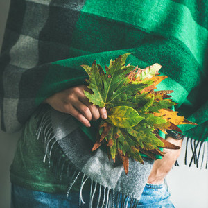 Woman in warm scarf or blanket with leaves  square crop