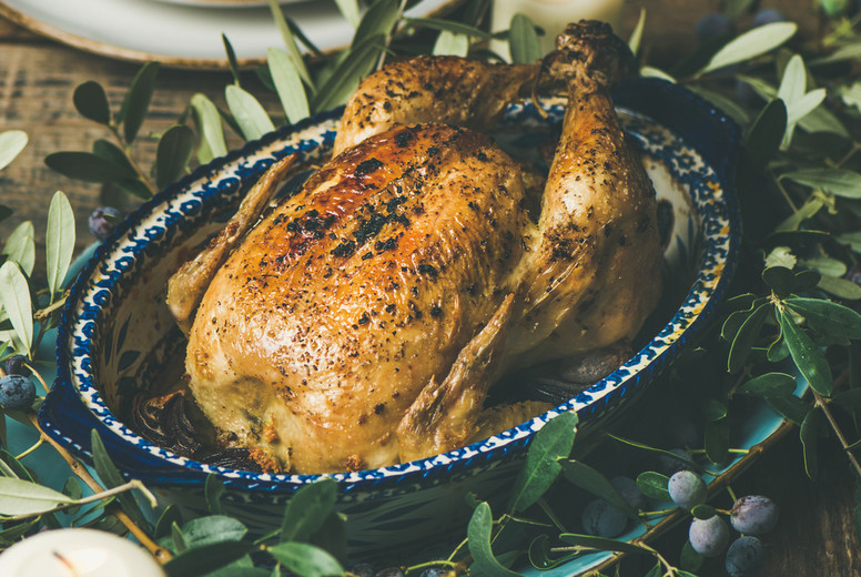 Whole roasted chicken decorated with olive tree branch