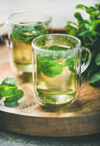 Hot herbal mint tea drink in glass mugs