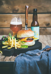 Classic burger dinner with beer and french fries  copy space