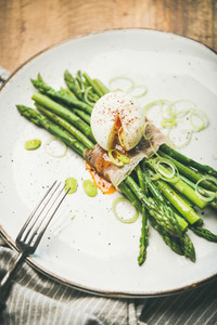 Green asparagus with soft boiled egg in white plate  selective focus