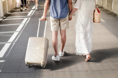 asian traveler couple with suitcase