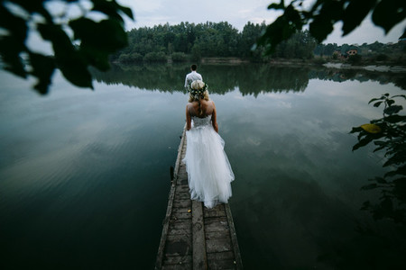 Wedding couple on the old wooden pier