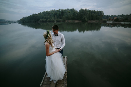 Wedding couple on the old wooden pier