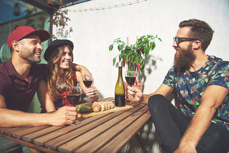 Bearded man with couple drinking wine