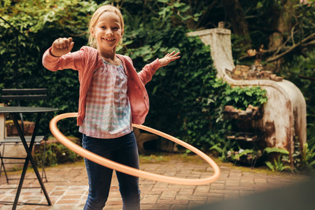 Girl playing with a hoopla ring