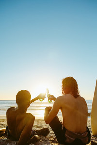 Surfers having beers on the beach