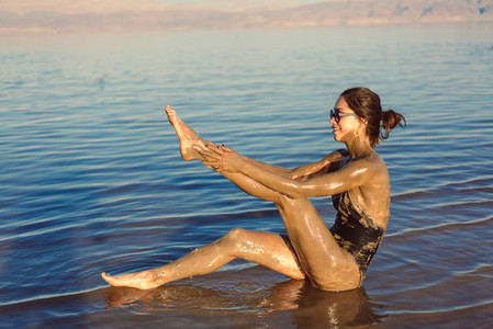 A young woman enjoying the natural mineral mud