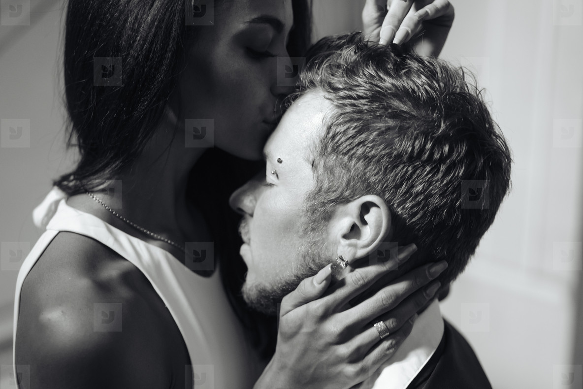 Beautiful  young couple posing on camera indoors