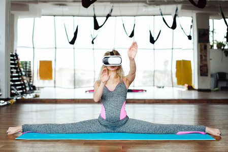 Woman in yoga class with VR headset