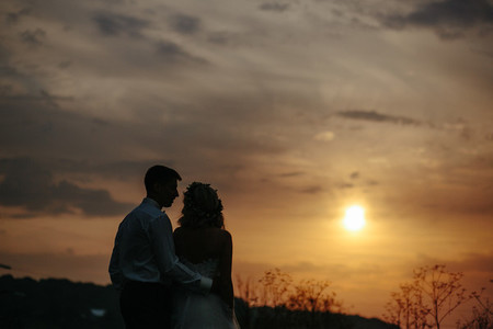 Silhouette of  wedding couple in field