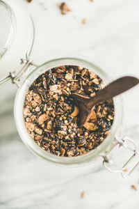 Buckwheat and granola with hazelnuts in jar with spoon