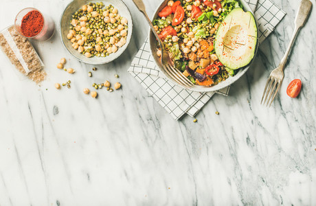 Vegan dinner bowl with avocado grains beans vegetables copy space