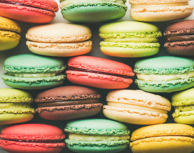 Colorful French macaroons cookies stacked in rows