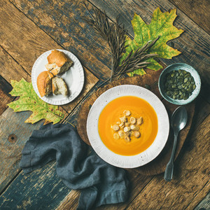 Warming pumpkin cream soup with croutons and seeds  square crop