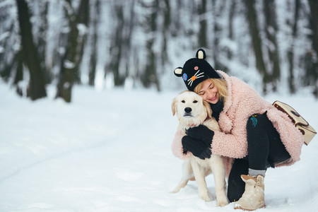 Happy smiling young woman with white dog
