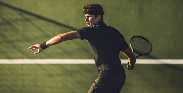Tennis player playing on hard court