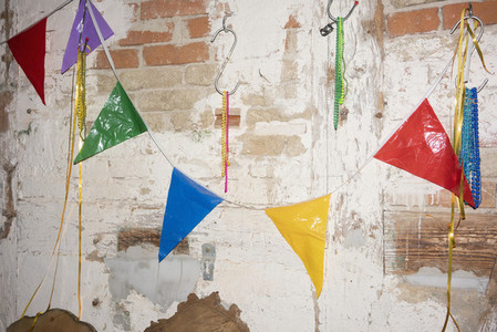 Multicolor bunting hanging on brick wall 01