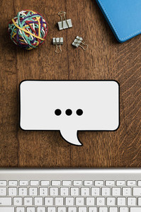 View from above paper speech bubble on wooden desk 01