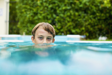 Portrait boy swimming in swimming pool 01