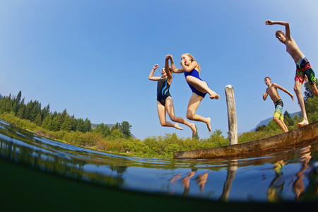 Kids jumping into sunny summer lake 01