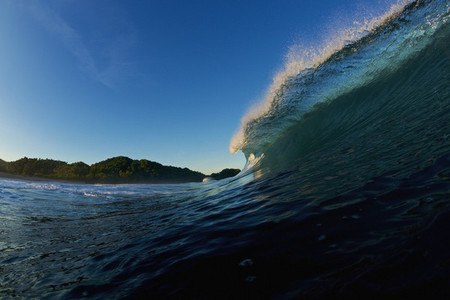 Breaking ocean wave at sunrise 01