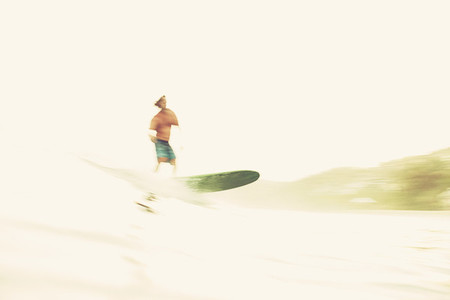 Male surfer riding wave on sunny ocean 01