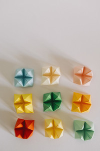 Multicolored origami fortune tellers on white background 01