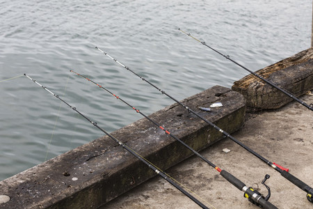 Fishing rods hanging over pier 01