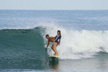 Young couple sharing surfboard 02