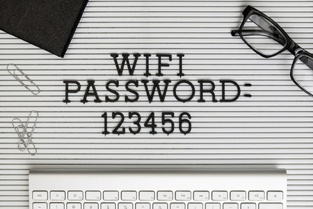 View form above Wifi Password 123456 on desk above computer keyboard 01