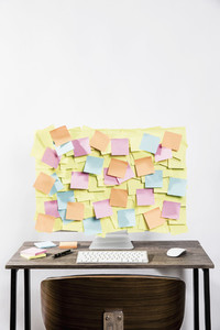 Adhesive notes covering computer in office 01