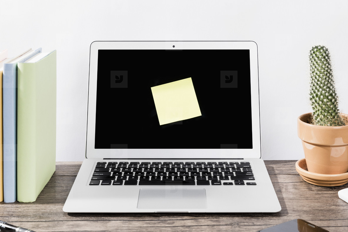 Blank adhesive note on laptop screen  01