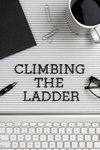 View form above Climbing the Ladder text on desk above computer keyboard 01