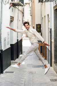 Young funny man jumping in the street