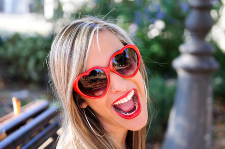 Funny girl with red heart glasses