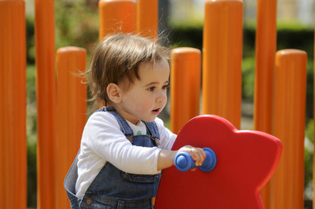 Little girl playing in a urban playground
