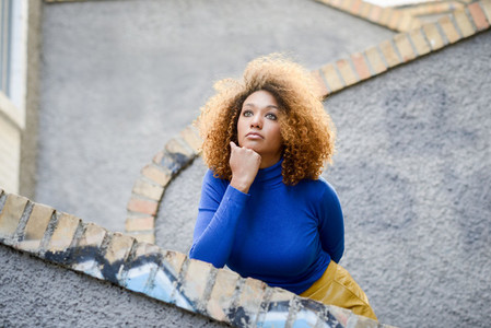 Young girl with afro hairstyle in urban background
