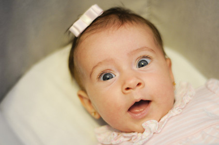 Little baby girl with surprise expression on her face