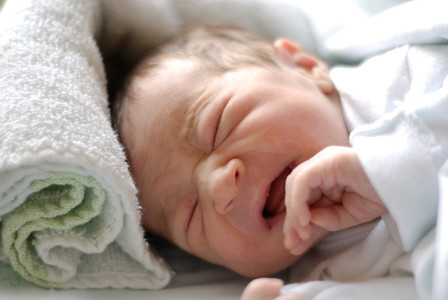 Newborn baby girl in hostpital bed sleeping