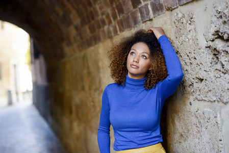 Young girl with afro hairstyle in urban background