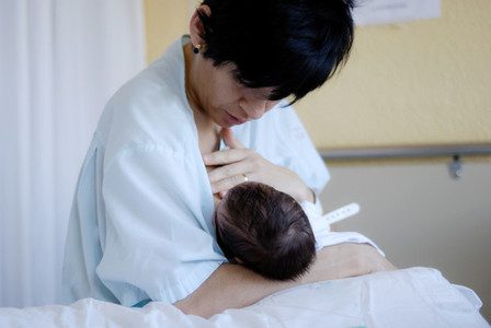 Mother feeding breast her newborn baby at the hospital