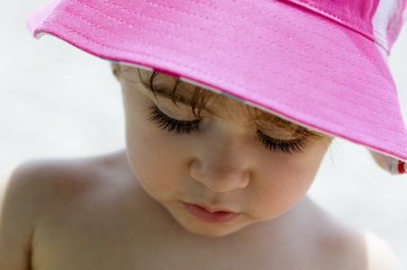Close up potrait of adorable little girl wearing sun hat