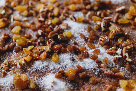 Close up of pie filling ingredients with traditional winter spices like raisins pecan cinnamon and sugar