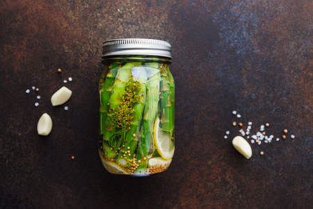 Top view of pickled asparagus in a jar  Seasonal canning vegetable recipe